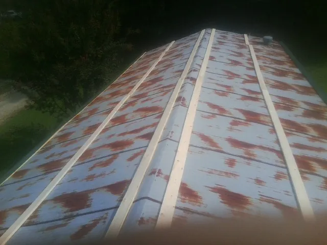 Rusted metal roof panels with new wood purlins before replacement — Storm Damage Roof Repair in Kintnersville by Roofing Brothers