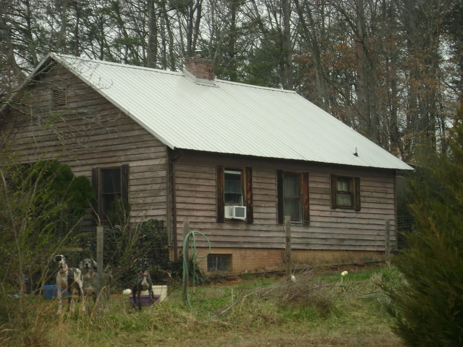 White metal roof on an old wood sided farmhouse, from a Metal Roof Installation job in Kintnersville